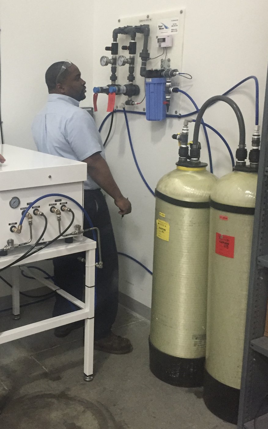 Deionization tanks and a wall-mounted blending panel at the label plant